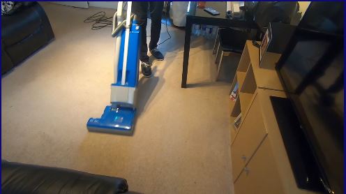 Cleaner vacuuming carpet